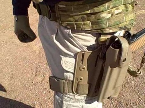 A drop leg holster with retention worn on the thigh