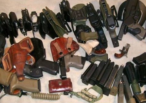 A table covered with leather, Kydex and nylon holsters from the Gun Websites collection