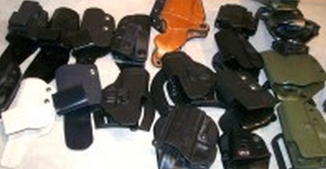 Kydex and leather holsters laid out side by side