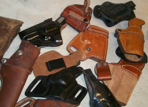 Brown and black leather holsters of several styles