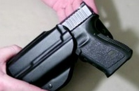 An outside the waistband holster with a pistol seated